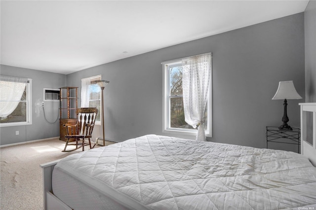 bedroom with carpet floors, baseboards, and a baseboard heating unit