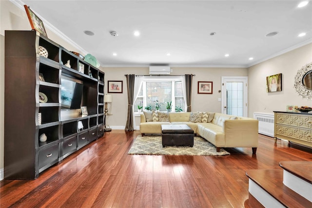 living room with radiator, a wall mounted air conditioner, crown molding, and hardwood / wood-style floors