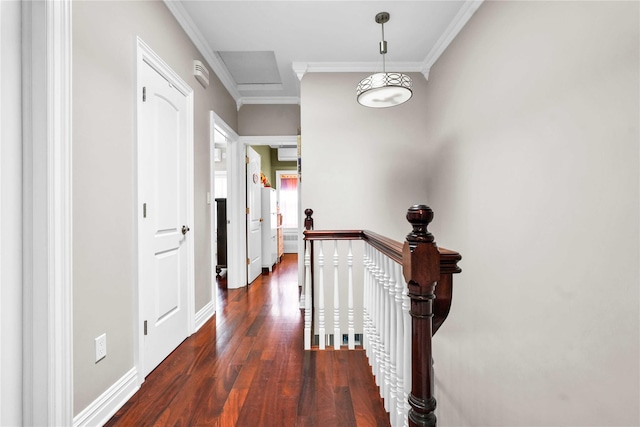 hall with dark wood-type flooring, an upstairs landing, baseboards, and ornamental molding