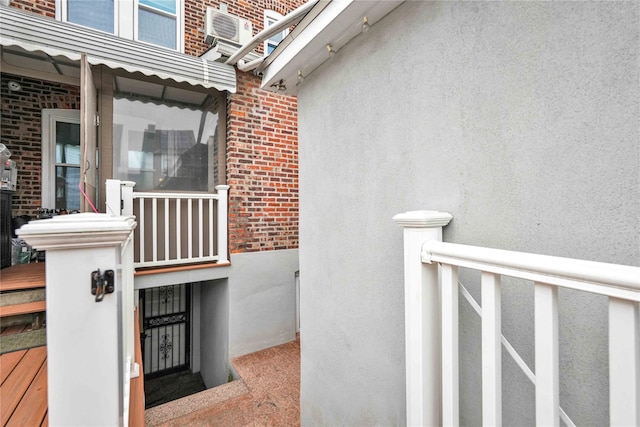 property entrance featuring brick siding and stucco siding