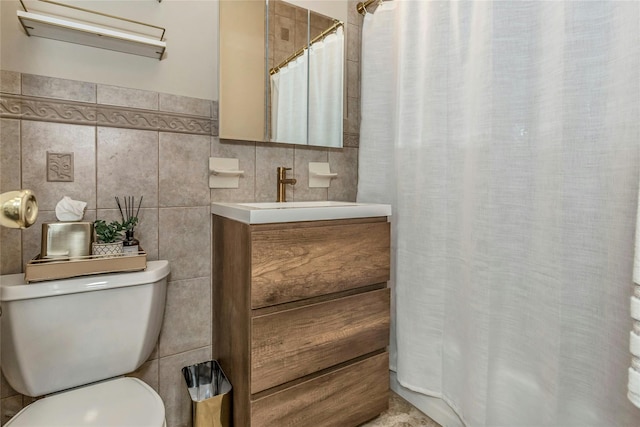 bathroom with a shower with shower curtain, toilet, tile walls, and vanity