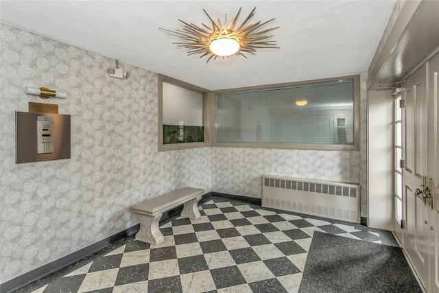 bathroom with tile patterned floors, baseboards, radiator, and wallpapered walls