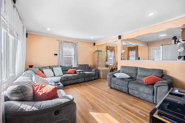 living area featuring recessed lighting, light wood-style flooring, and ornamental molding