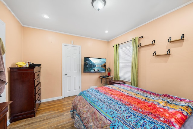 bedroom featuring recessed lighting, crown molding, baseboards, and wood finished floors