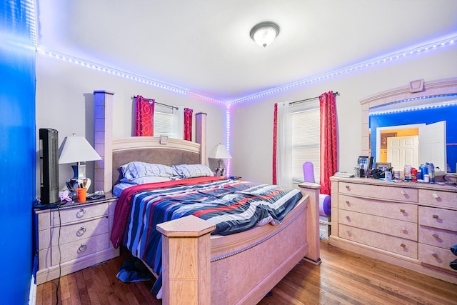 bedroom with hardwood / wood-style floors