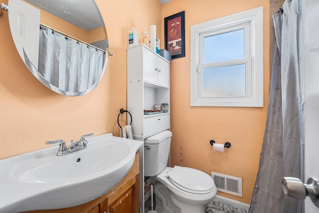 bathroom featuring visible vents, curtained shower, toilet, and vanity