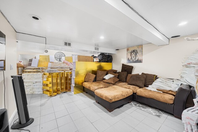 tiled living room featuring visible vents