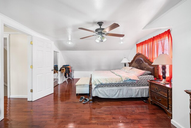 bedroom with baseboards, a ceiling fan, lofted ceiling, and hardwood / wood-style floors