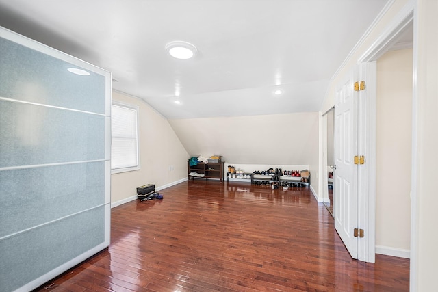 additional living space with baseboards, lofted ceiling, and hardwood / wood-style flooring