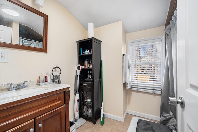 bathroom with tile patterned flooring, vanity, and baseboards