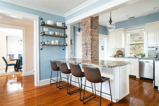 kitchen with visible vents, light stone counters, stainless steel dishwasher, dark wood finished floors, and white cabinetry