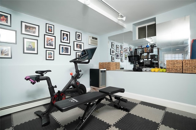 exercise area with baseboards and baseboard heating