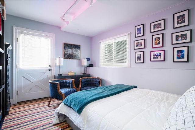 bedroom featuring carpet flooring and multiple windows