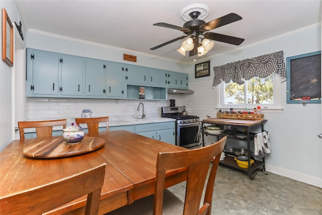 kitchen featuring a sink, gas stove, blue cabinets, and crown molding