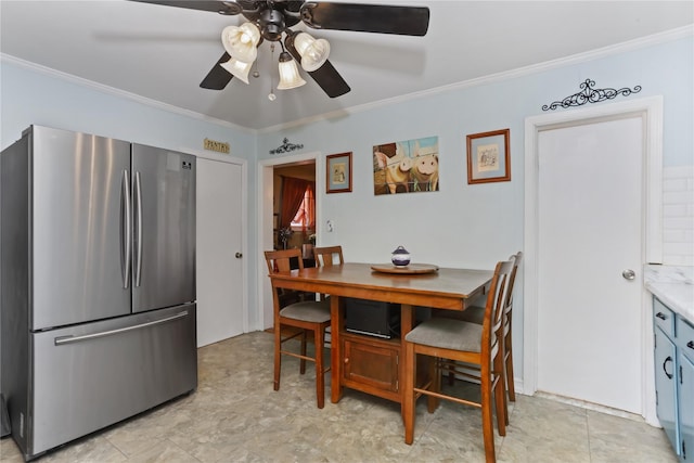 dining area featuring ceiling fan and crown molding