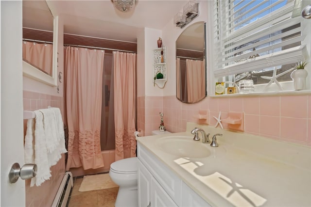 full bath featuring vanity, shower / bath combo with shower curtain, a baseboard heating unit, tile walls, and toilet