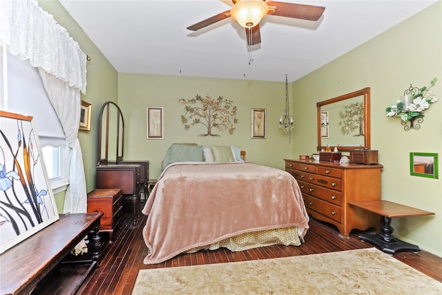 bedroom with a ceiling fan and dark wood-style flooring