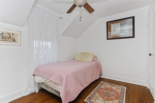 bedroom with a ceiling fan, vaulted ceiling, wood finished floors, and baseboards