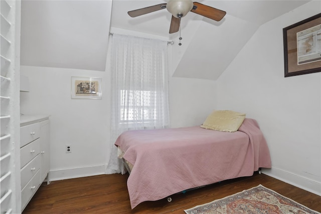 bedroom with baseboards, lofted ceiling, and wood finished floors