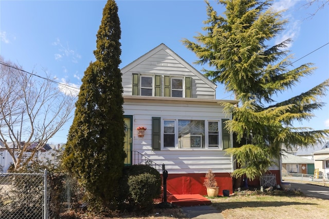 view of front of home featuring fence