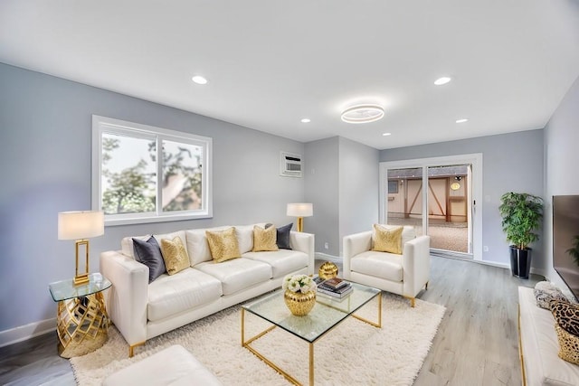 living room featuring light wood-style flooring, baseboards, and recessed lighting