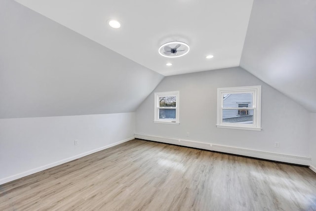 bonus room featuring baseboards, a baseboard radiator, wood finished floors, vaulted ceiling, and recessed lighting