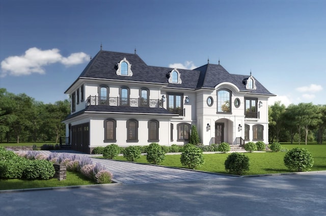 view of front of property with a garage, a balcony, decorative driveway, a front lawn, and stucco siding