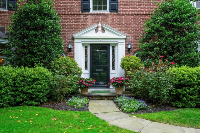 view of exterior entry with brick siding