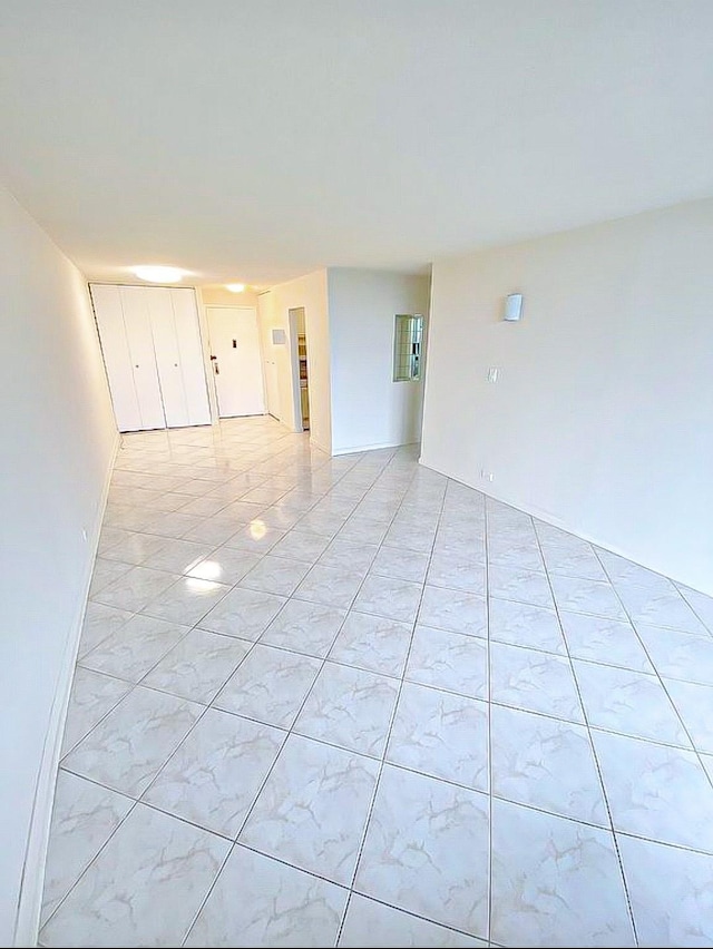 empty room with light tile patterned floors