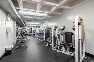 gym featuring coffered ceiling