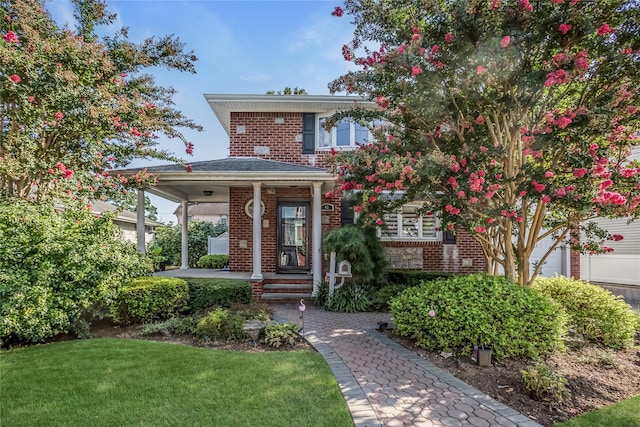 view of front of home featuring a front yard and brick siding