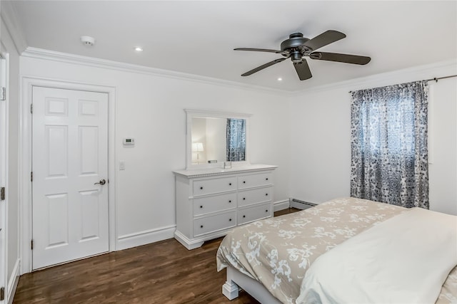 bedroom featuring ornamental molding, baseboard heating, dark wood finished floors, and baseboards