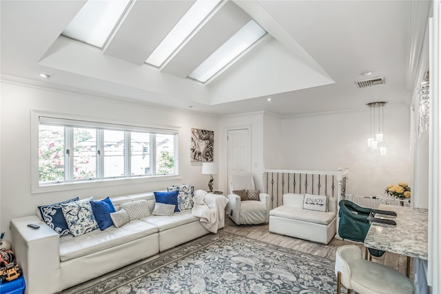 living room with a skylight, wood finished floors, visible vents, and crown molding