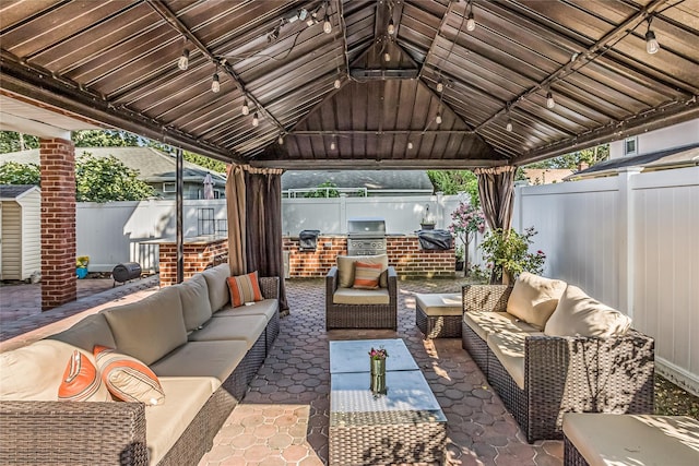 view of patio / terrace featuring a fenced backyard, grilling area, and a gazebo