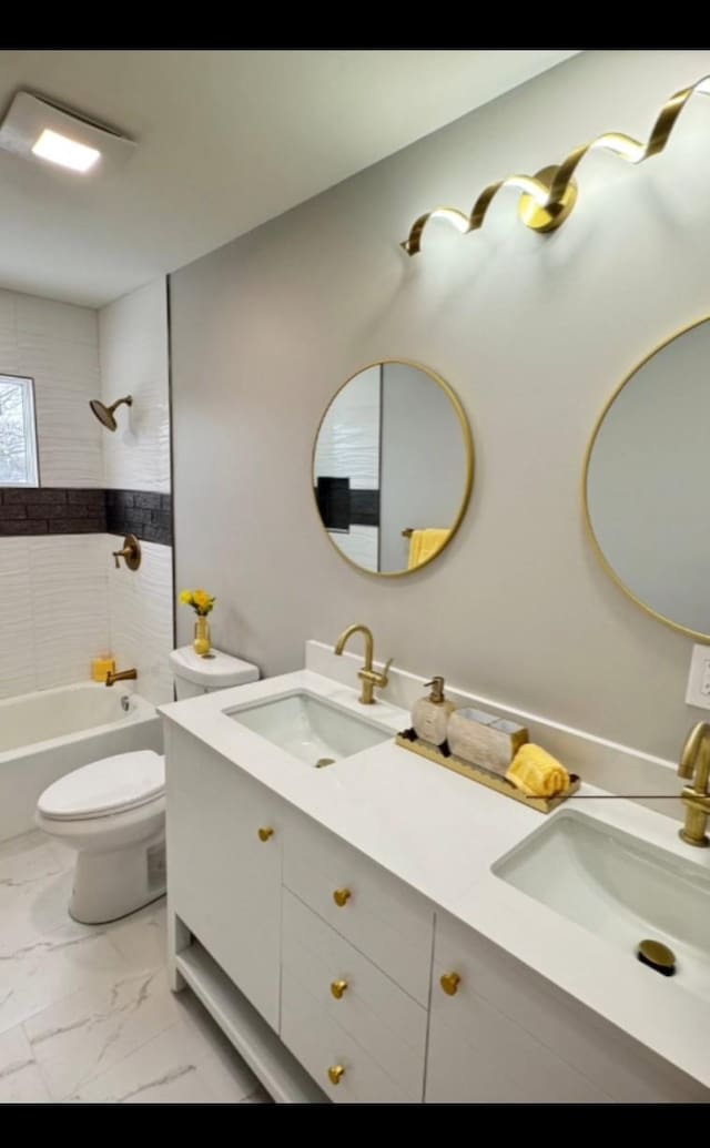 full bath featuring toilet, marble finish floor, shower / tub combination, and a sink