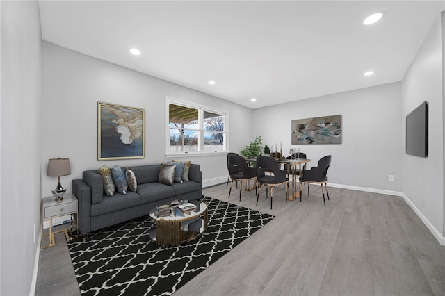 living room featuring recessed lighting, baseboards, and wood finished floors