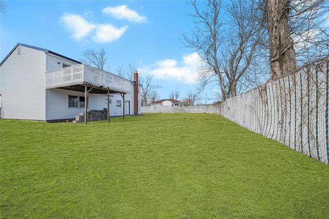 view of yard with a fenced backyard and a wooden deck