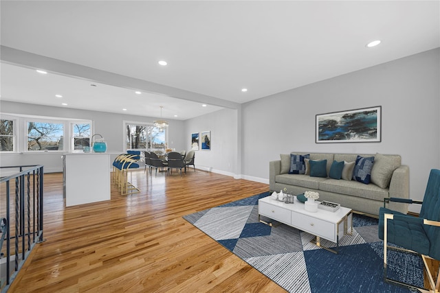 living area featuring light wood finished floors, recessed lighting, and baseboards