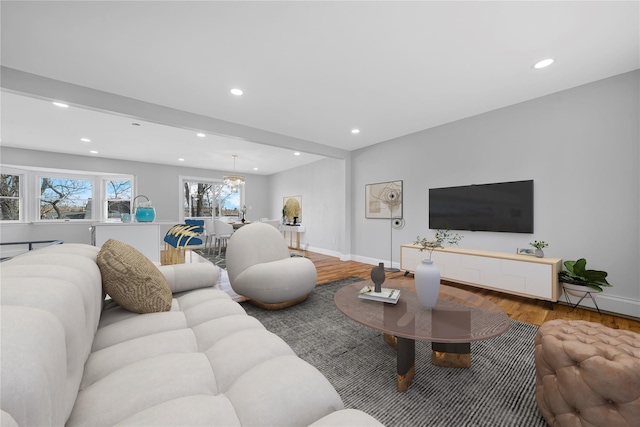 living area featuring recessed lighting, wood finished floors, and baseboards