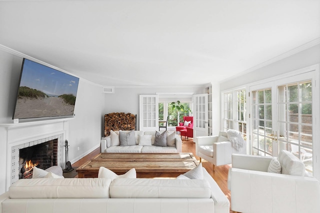 27 Notamiset Rd, Westhampton Beach, NY 11978 - living area featuring wood finished floors, baseboards, a lit fireplace, french doors, and crown molding