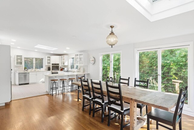 27 Notamiset Rd, Westhampton Beach, NY 11978 - dining space featuring light wood-type flooring, a skylight, and recessed lighting