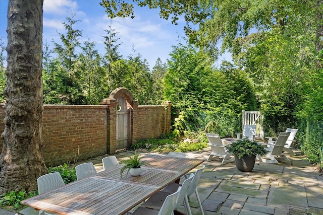 27 Notamiset Rd, Westhampton Beach, NY 11978 - view of patio featuring outdoor dining area, fence, and a gate