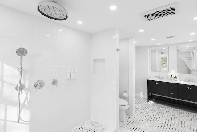27 Notamiset Rd, Westhampton Beach, NY 11978 - full bath with double vanity, visible vents, a tile shower, and a sink