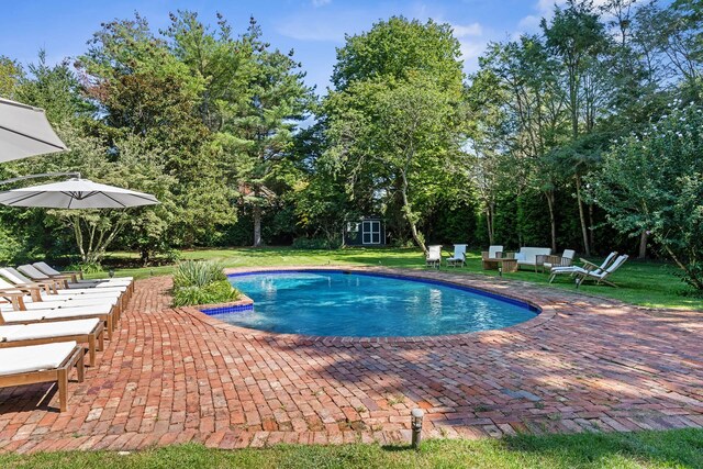 27 Notamiset Rd, Westhampton Beach, NY 11978 - pool featuring an outbuilding, a patio area, and a lawn