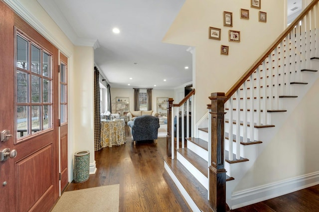 entrance foyer with dark wood-style floors, ornamental molding, a barn door, and recessed lighting