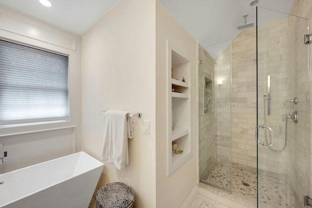 bathroom with visible vents, lofted ceiling, a soaking tub, a shower stall, and built in shelves