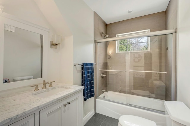 full bathroom with toilet, shower / bath combination with glass door, tile patterned floors, and vanity