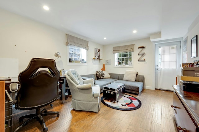 living area featuring wood finished floors, a wealth of natural light, and recessed lighting