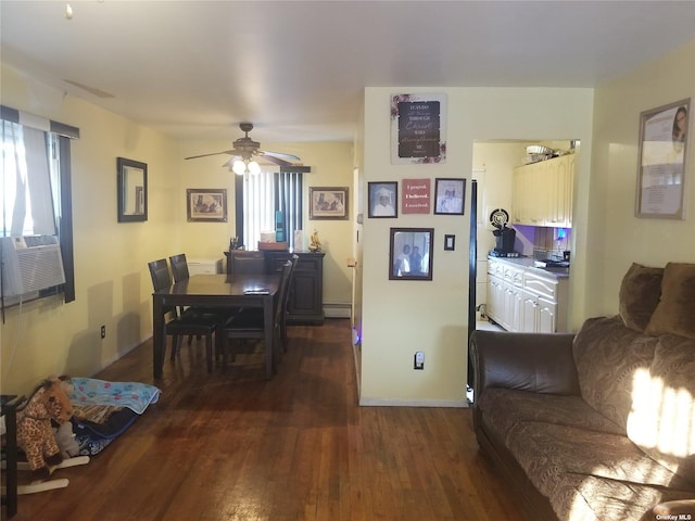 dining area with plenty of natural light, baseboards, baseboard heating, and dark wood-type flooring