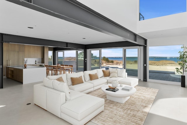 living area with a towering ceiling and light tile patterned floors